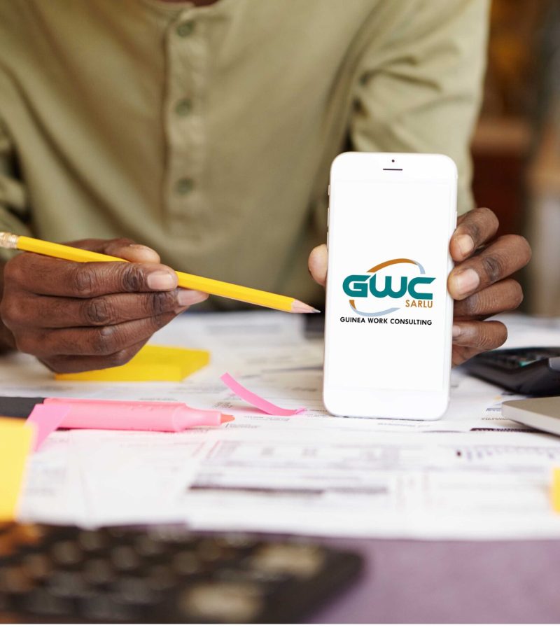 unrecognizable-african-man-holding-yellow-pencil-pointing-it-blank-screen-smart-phone-his-hand